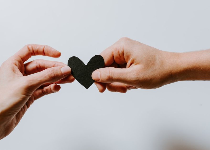 Hands holding a heart-shaped paper. Photo by Kelly Sikkema on Unsplash