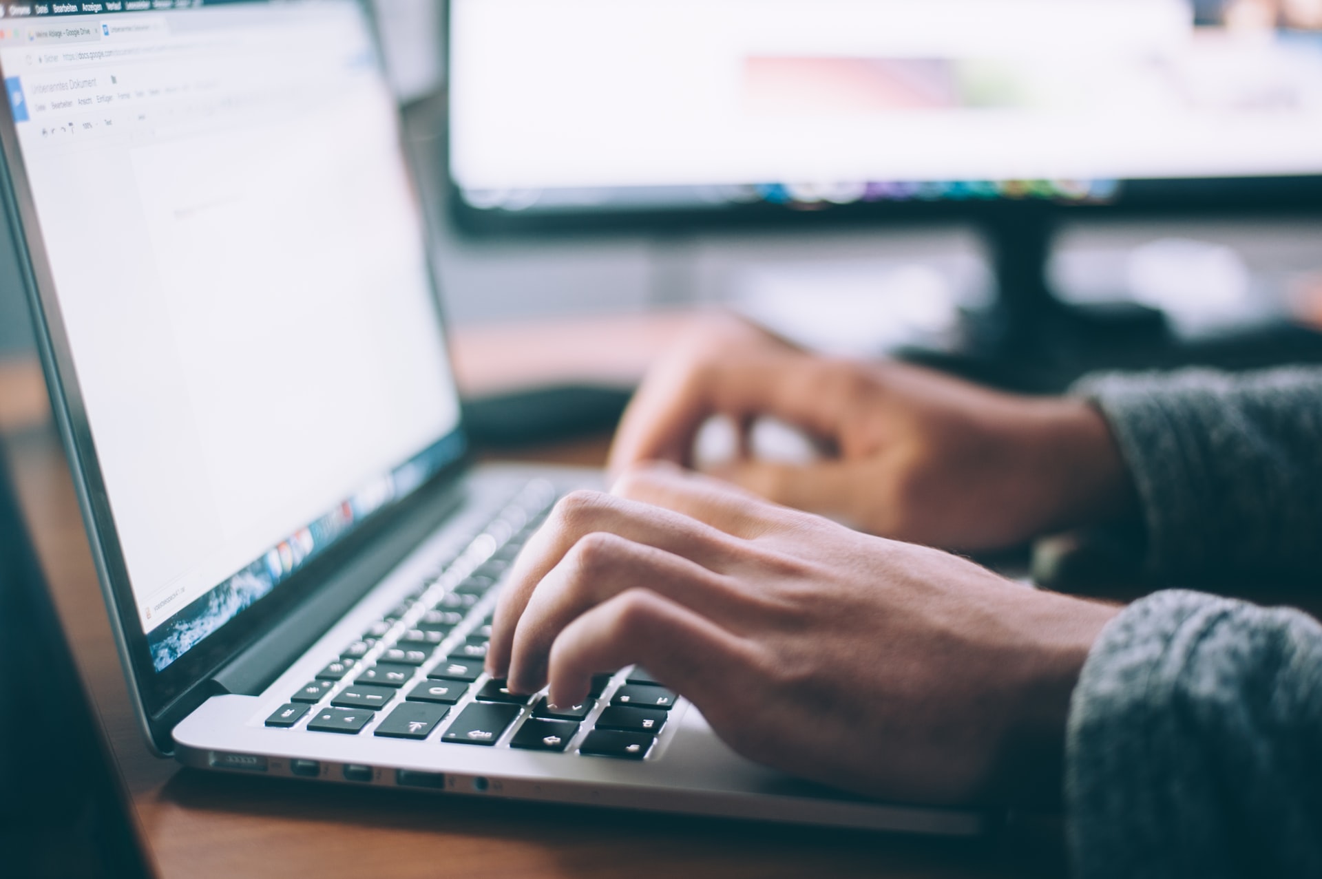 Hands typing on laptop keyboard. Photo by Glenn Carstens-Peters on Unsplash