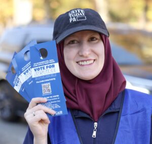 Voter Outreach Worker with "Vote for Justice" Information - CAIR-Philadelphia