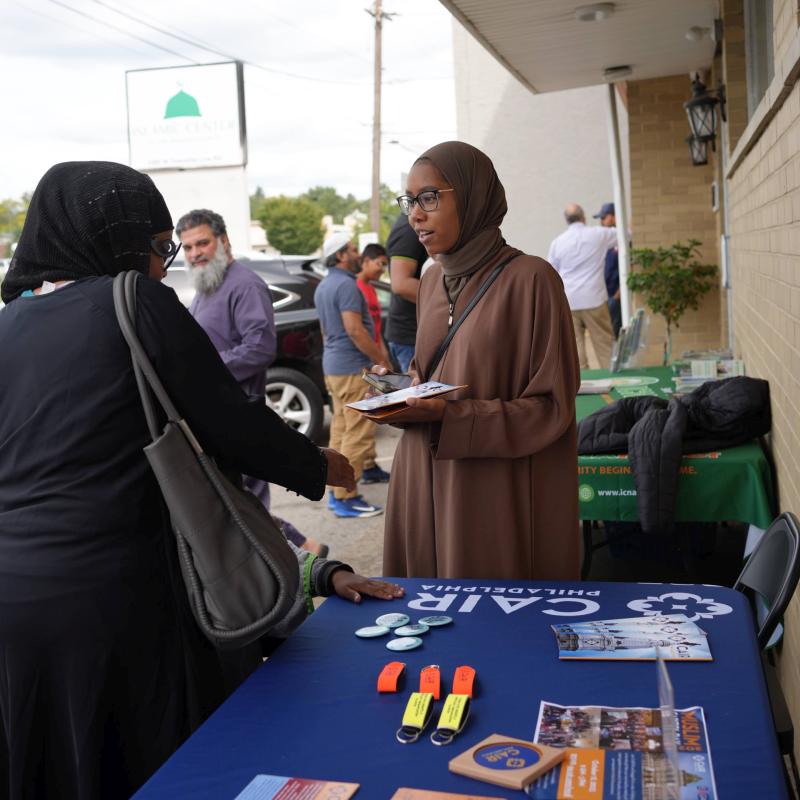 Advocacy Projects Director Asiyah Jones distributing information to community members.